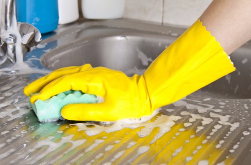 Professional cleaners maintaining desks and shared workstations in Kensington
